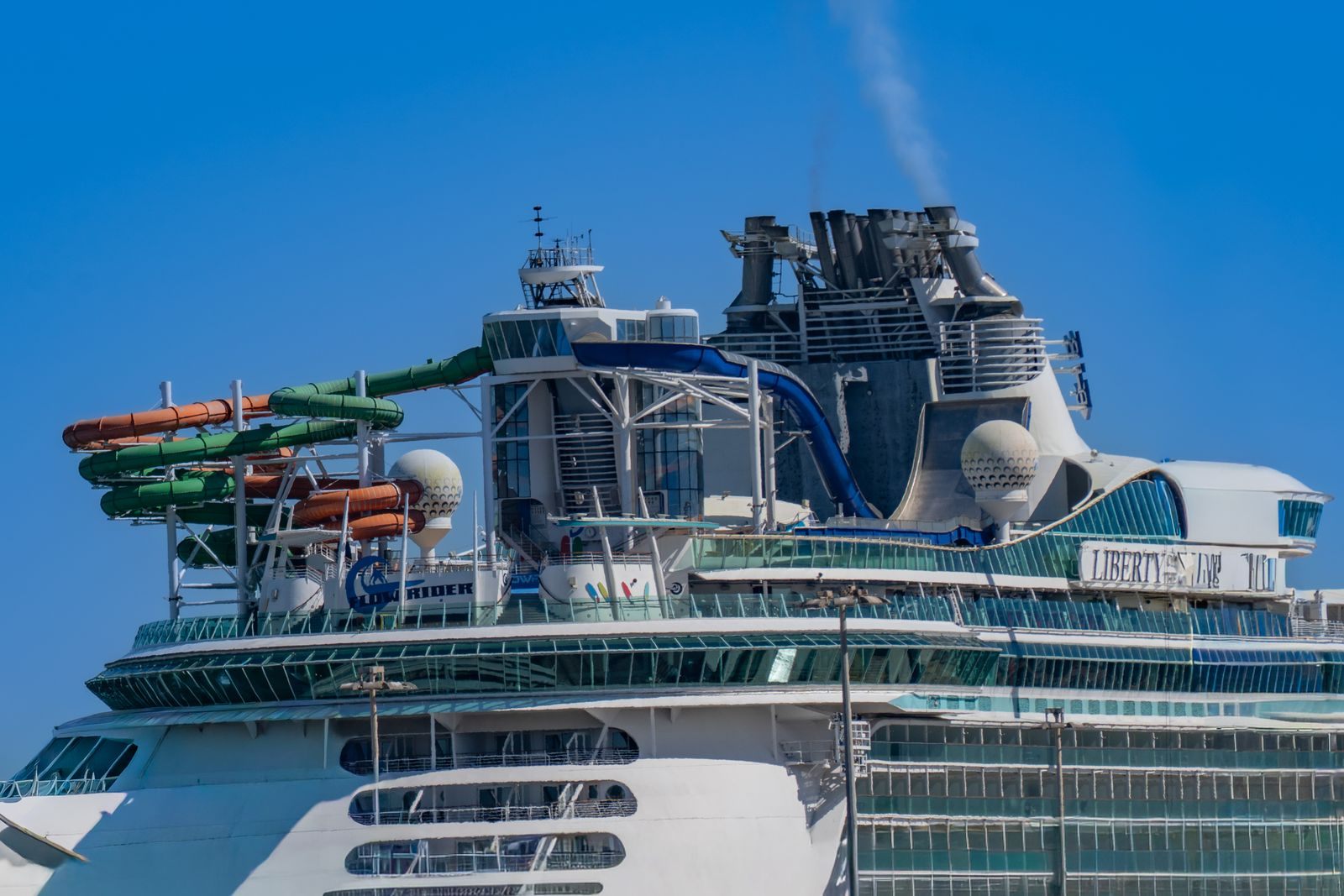 Top deck of a big cruise ship crowded with twisting water slides, part of how the worlds largest cruise ship capacity is spread out