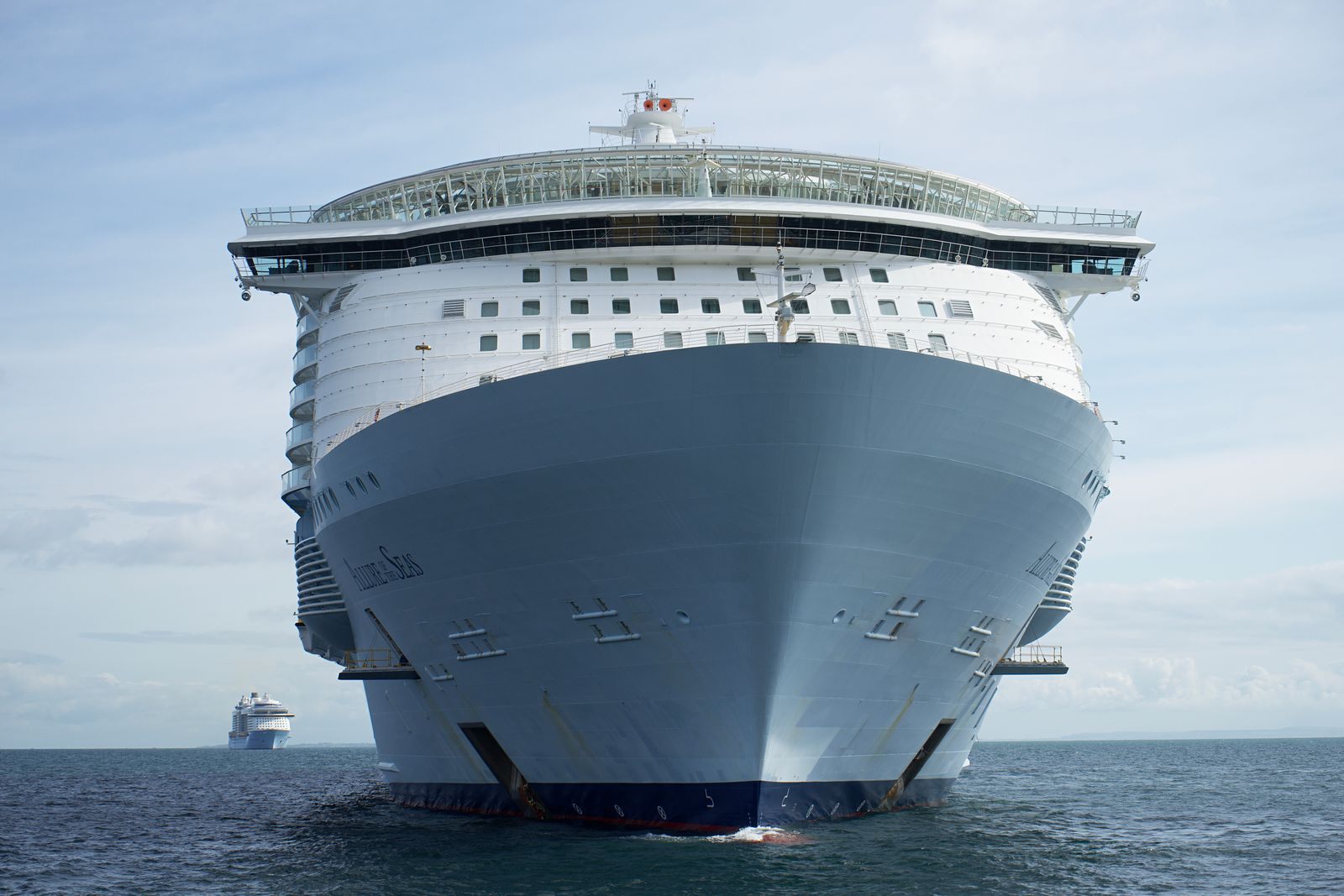 Huge white cruise ship seen bow-on at sea, one of the biggest cruise ships in order of size