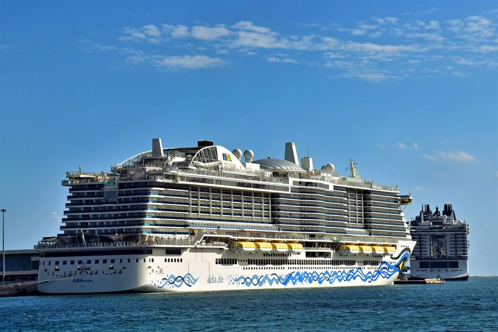 Large cruise ships berthed at the Port of Barcelona under a blue sky
